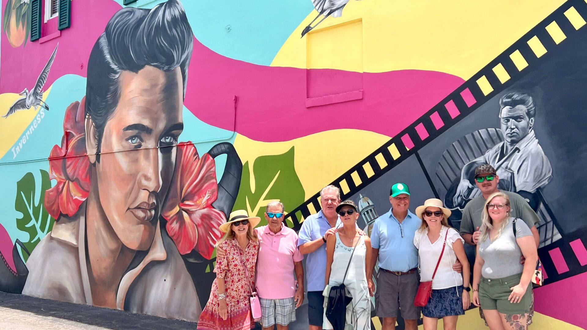 Guests on the Inverness Food Tour posing in front of the Elvis Presley mural in downtown Inverness, Florida