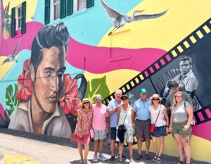 Guests on the Inverness Food Tour posing in front of the Elvis Presley mural in downtown Inverness, Florida