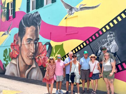 Guests on the Inverness Food Tour posing in front of the Elvis Presley mural in downtown Inverness, Florida