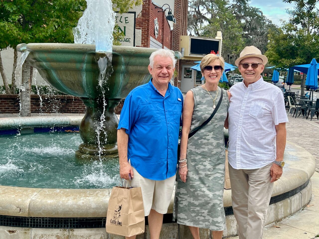 Happy group smiling by a fountain in downtown Inverness, Florida during a Tastes & Tales Food Tour
