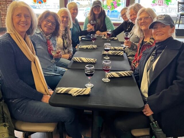 Group of happy guests enjoying wine tasting on the Crystal River Food Tour in Citrus County, Florida.