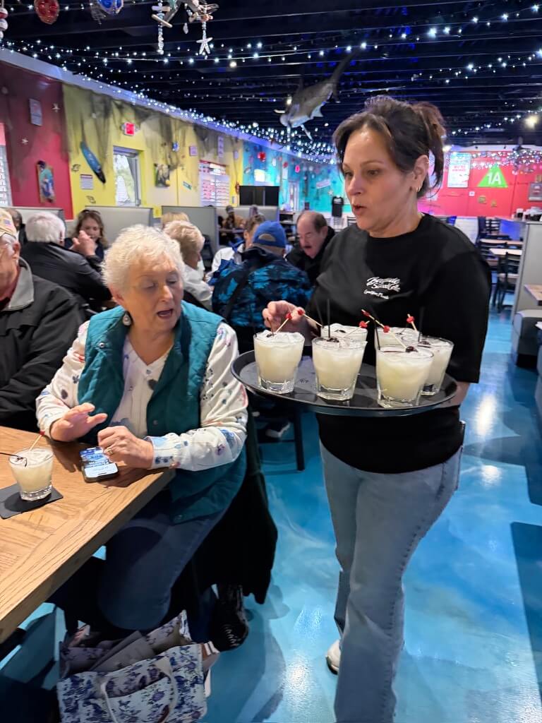 Guests from The Villages enjoying piña coladas at Bayside Seafood Grille on a Crystal River food tour