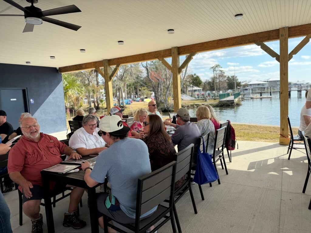 Guests dining at the Crab Plant on Kings Bay during a Crystal River food tour